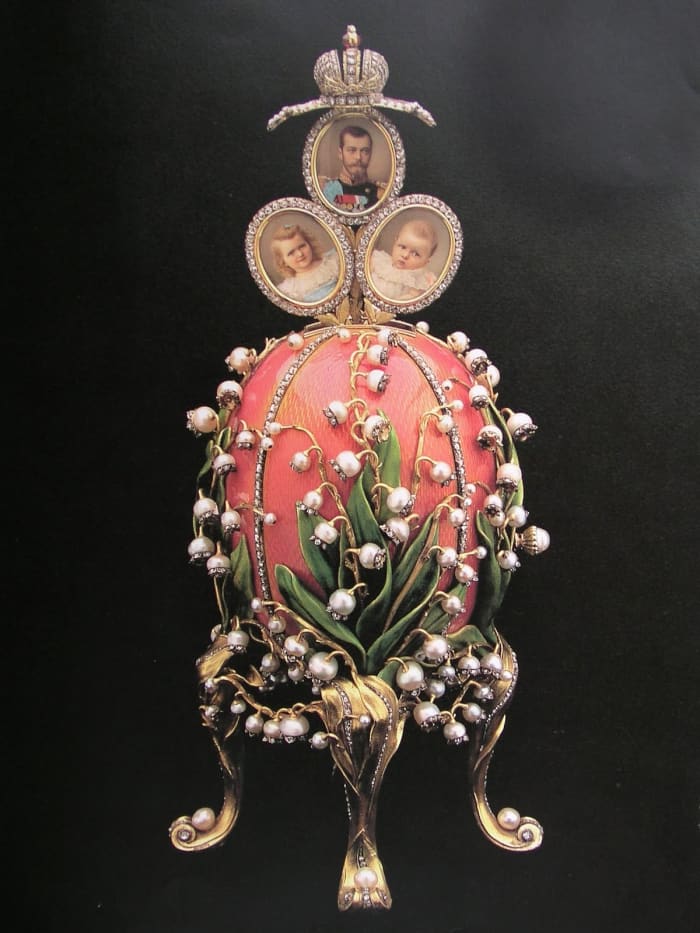 Emperor Nicholas II also presented this Lilies of the Valley egg to his wife in a style she loved with the flower that was her favorite. The 'surprise' inside was a trio of family photographs.