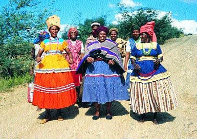 Basotho women dressed in their Sotho cultural dresses, along with embroidery on their dresses and beads in their hands and necks