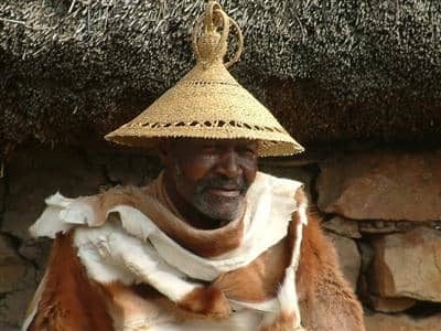A Mosotho man wearing his hat(Modianyewo), and also wearing a goat or cow skin(most times they wear a blanket because Lesotho on the top of the mountains is a cold place