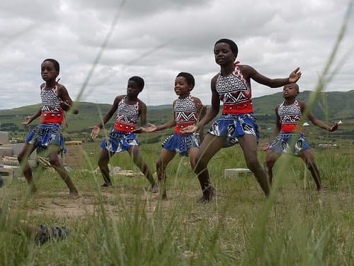 Swazi kids entertaining tourists clad in traditional garb and performing traditional and customary dances