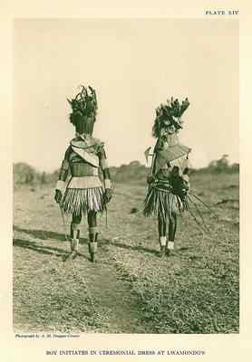 This is how the initiates for circumcision looks like. The dress abpove and the one wonr by the two men disguises them, and one here is crrying a typical old-fashined Venda battle axe
