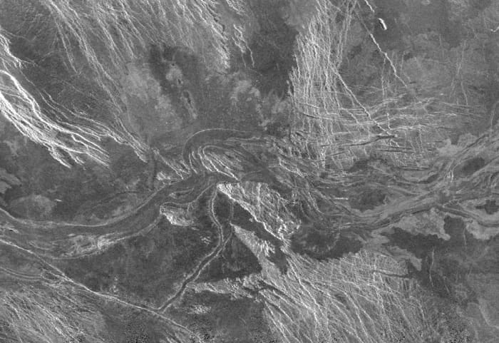 Running west to east across the centre of this image is part of a 1,200 km long by 20 km wide (750 miles by 12 miles) lava channel in the Lada Terra region of southern uplands. The picture covers a total area 200 km wide