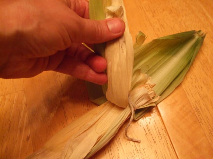 Invert the husks one at a time over the head "bulb." This is similar to taking off a T-shirt over one's head.