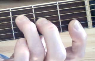 This is the normal F Major shape. The first finger barres the E and B strings. You may have to curve your finger slightly or even fret the two strings with the tip of your index finger.