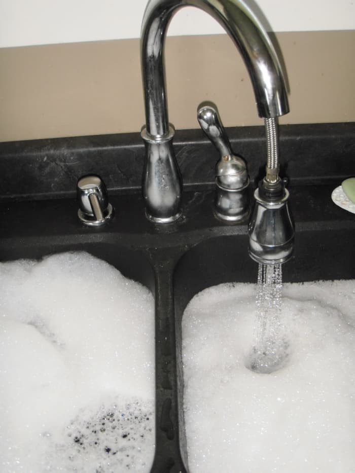 To prevent a clogged kitchen sink, on a monthly basis fill the sink or tub to the brim with hot water.