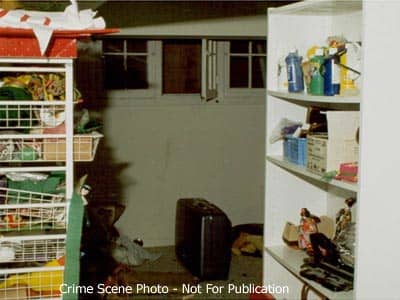Crime scene photo. The window is open, you can see the scuff on the wall and the suitcase is under the window.