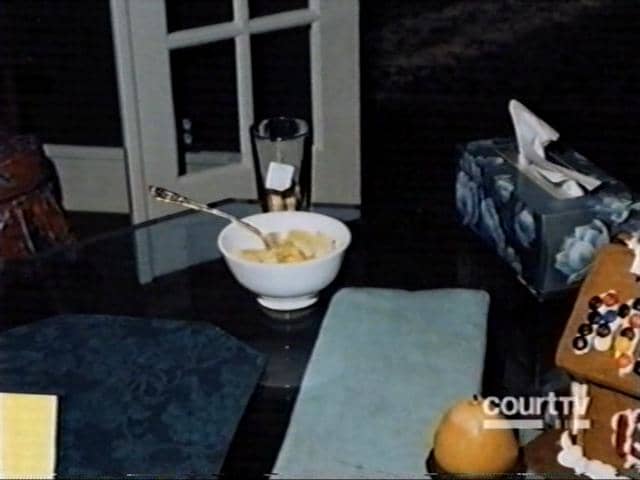 Crime scene photo of the bowl of pineapple and glass of tea found on the dining room table.