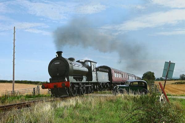 65894 passes Crake Hall level crossing on her last but one day of running on the Wensleydale Railway (note photographer's vintage car to the right of the gates)