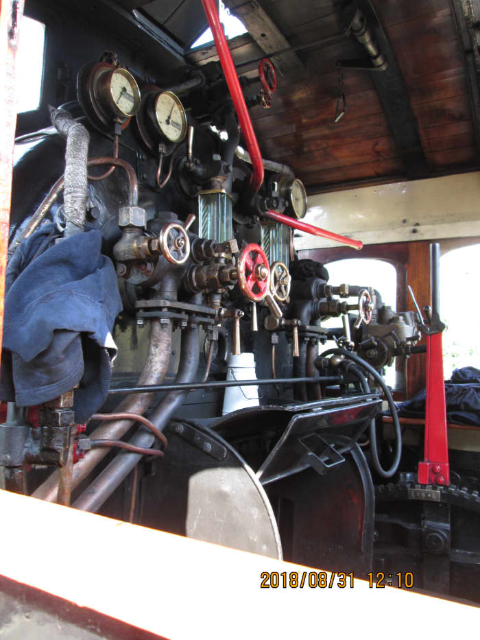Some of said moving parts on show through the cab side window - fireman's side, featuring the traditional white enamel tea can and cup (with handle, centre), shortly to be joined by one for the driver