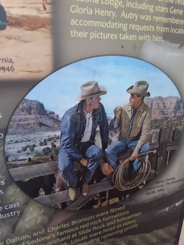 A scene from The Rounders with Glenn Ford and Henry Fonda, featuring Bell Rock in the background. Photo taken of a film display at the Sedona Heritage Museum.