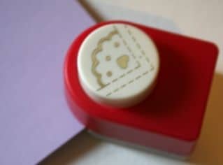 Just slide you paper into the corner of the cutter, making sure it fits snugly against the guides. Like this: