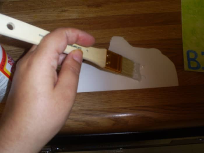 Here I am using mod-podge to attach the pop-up image to the card. Using a glue stick or double sided tape is another alternative.