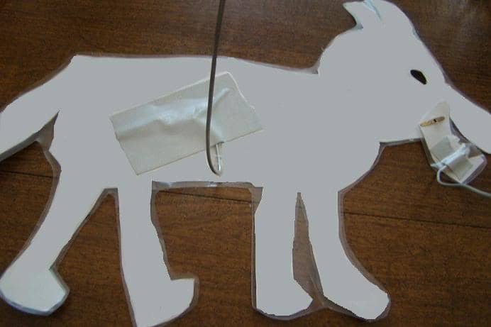 Notice that both the body of the puppet, plus his movable mouth, have wires attached.
