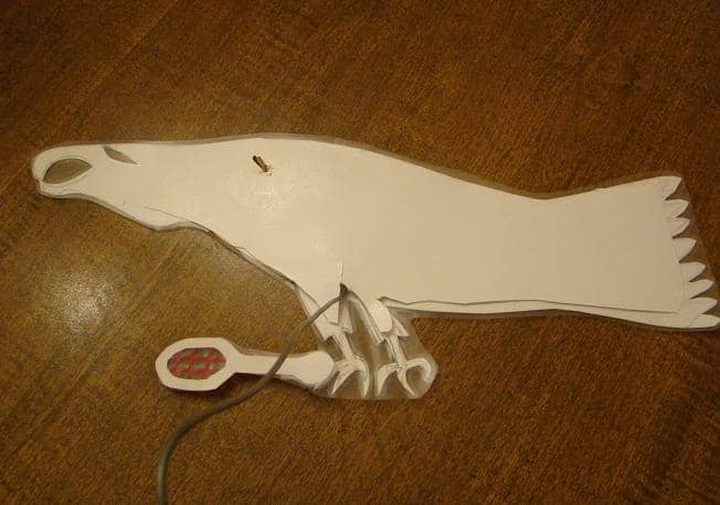 Eagle holding removable racket. During part of the play, the characters needed to be holding rackets, so we attached the rackets with a small ball of tape rolled sticky side out.