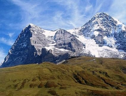 The Eiger North Face and the Moench towering above the alpine meadows of the Kleine Scheidegg. Photo by cable1