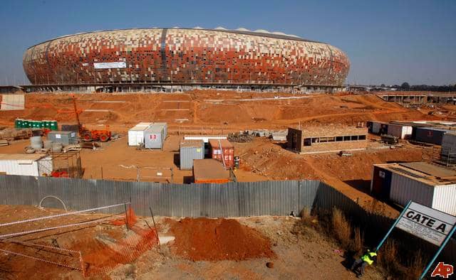 FNB or Soccer City City modelled like an African Calabash being prepared for 2010 next to Soweto Highway