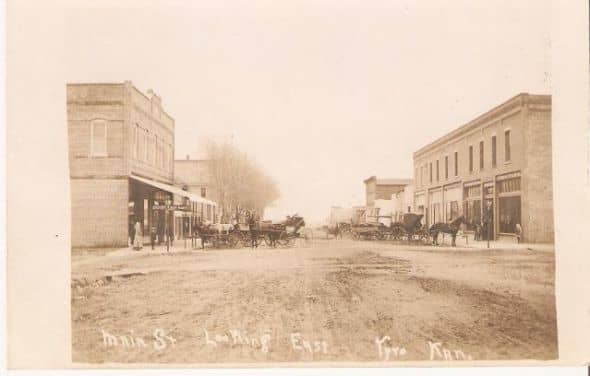 His description of the scene: Downtown Main Street looking east. The IOOF bldg is n left forefront and the hotel is east of it. The Deuel store is in right forefront.