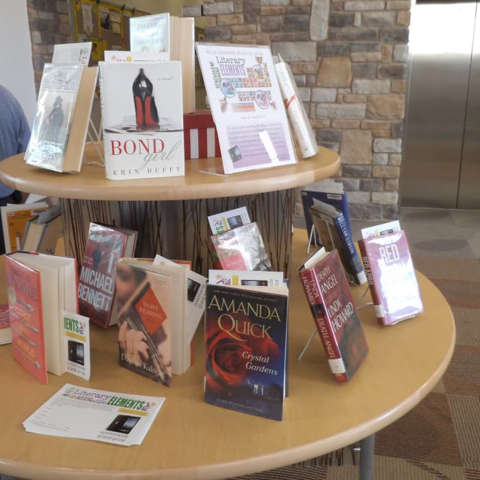 You can stand the book up by fanning out the pages or get some slim wire racks to place the books upright on the tabletop display.