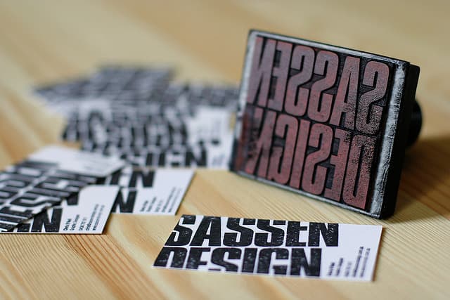 The business name in this case is printed using a custom rubber stamp, and because of the relatively large ink area on the text, the ink creates a naturally 'distressed' effect - which looks pretty funky!