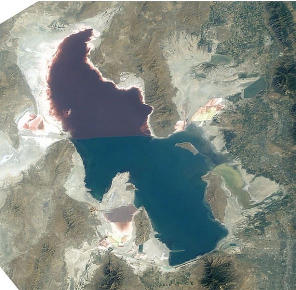 An aerial view showing the diffence in color of the lake on either side of the causeway. The pinkish color is caused by an algae.