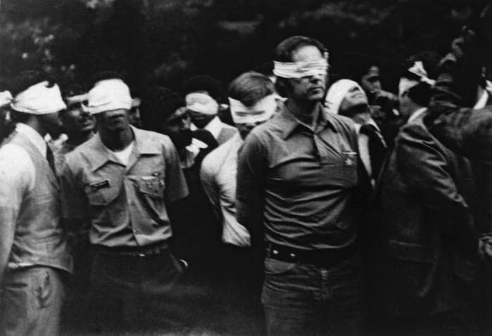 AMERICAN DIPLOMATS TAKEN HOSTAGE FOR 444 DAYS BY ISLAMIC REVOLUTIONARIES IN IRAN, PARADED BEFORE TELEVISION CAMERAS