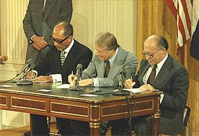PRESIDENT CARTER SIGNS THE CAMP DAVID ACCORDS WITH ANWAR SADAT OF EGYPT AND MENACHEM BEGIN OF ISRAEL