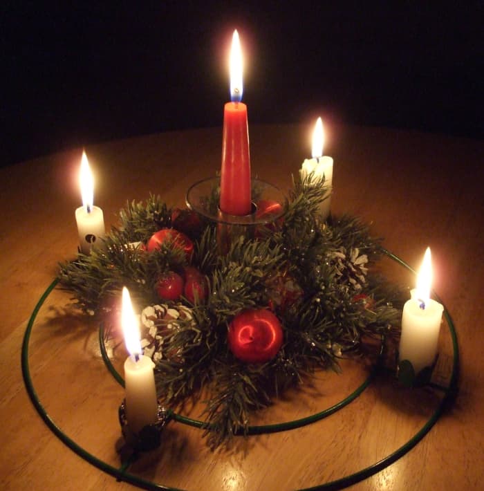 The plastic wreath of winter greens is a decorative touch for the Advent supplies, but not liturgically needed. In this photo my center candle is in a candleholder, but in the past it was often secured in a short glass with crumpled aluminum foil.