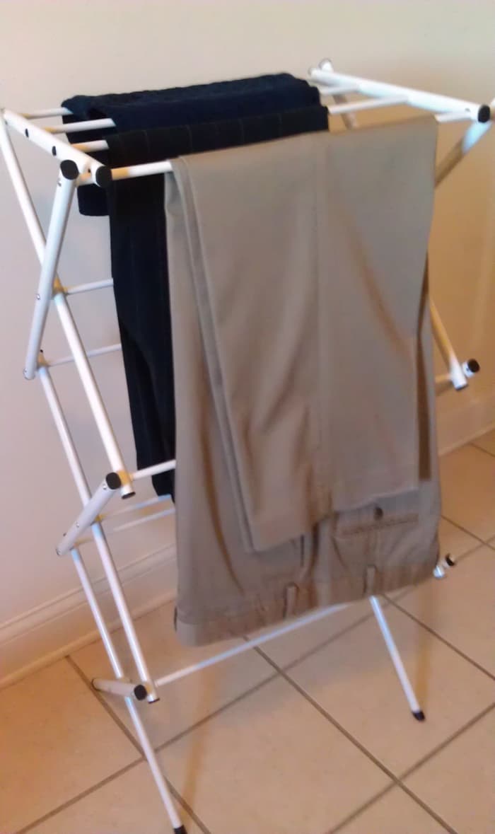 Hang damp trousers on a laundry rack and smooth out the wrinkles. If you like a front crease, pinch and smooth with your fingers. Let dry and no iron needed!