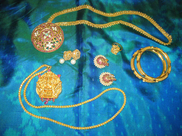 Temple jewelry included a chain, necklace, two pairs of earrings, bangles and ring with a silk saree as the background