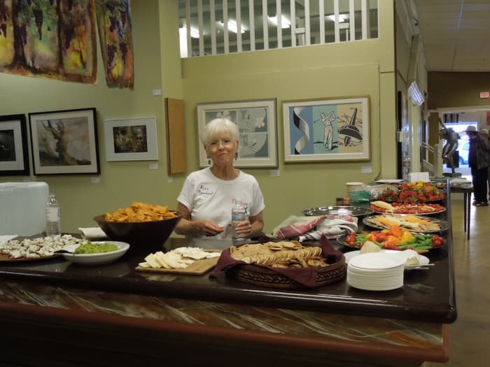 The artists provided and served this delicious buffet. Later on, they replenished it with desert foods. It was much appreciated by all. Don't forget to notice the banners hanging on the left above the buffet.
