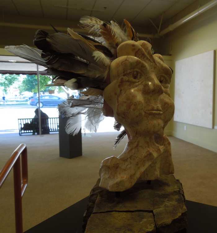"Iris" by Catherine Verhulst, made with sandstone, feathers, and clay