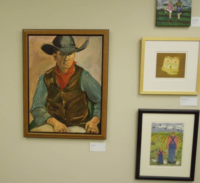 I call this the western wall. The two paintings above were also on it. To the left is "Cowboy" by Carmen Fojo, in oils. At the lower right is "Grandfather's Fields" by Earlene Vaughn, intaglio print.