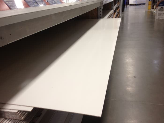Touch it & it should Feel soft like a whiteboard...Heck Even Bring a Marker with you & an eraser so you can test it (just make sure nobody sees you!)