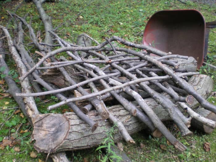 Interweave the branches at the base for a more stable pile. This method also leaves lots of room for birds to enter and explore.