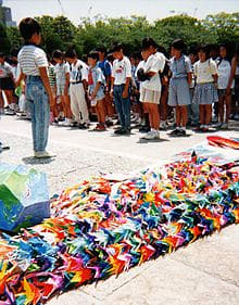 A group of Japanese schoolchildren dedicate their contribution of a thousand origami cranes at the Sadako Sasaki memorial in Hiroshima.