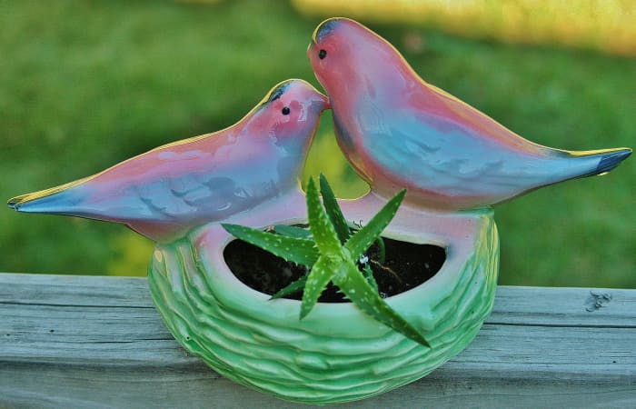 Planters featuring birds, lambs, kittens & other motifs appropriate for children's rooms make unique, inexpensive gifts for new parents.
