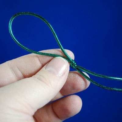 Make a simple loop about 2-3 inches long. Leave a couple of inches of loose ends, so there's no danger of the knot coming undon