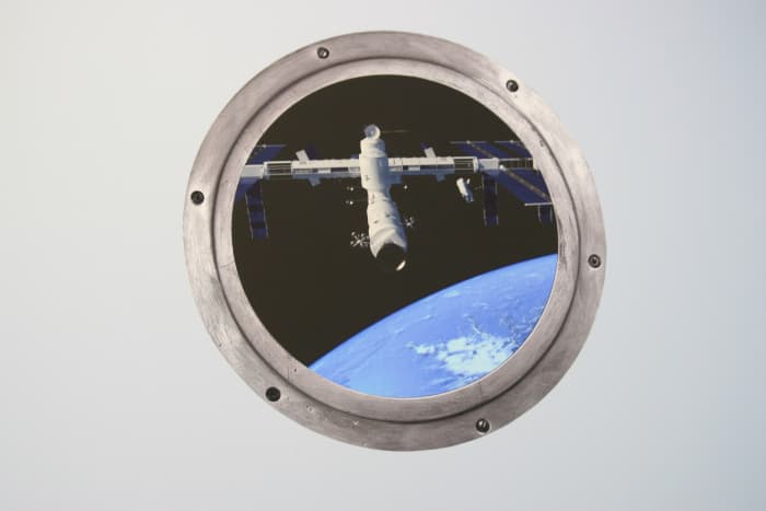 A space "porthole" wall decal ordered from Etsy. This decal cost approximately $13 and adds punch to the room.