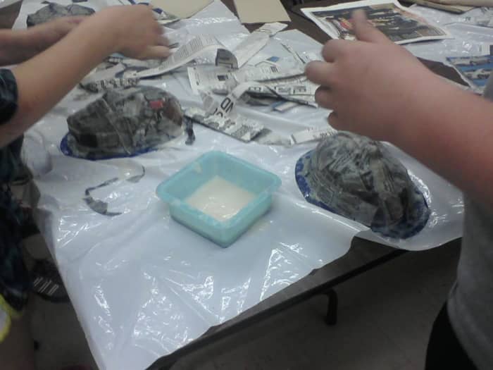 The students should use at least three layers of paper mache to make the masks sturdy, the more layers of paper, the stronger the mask