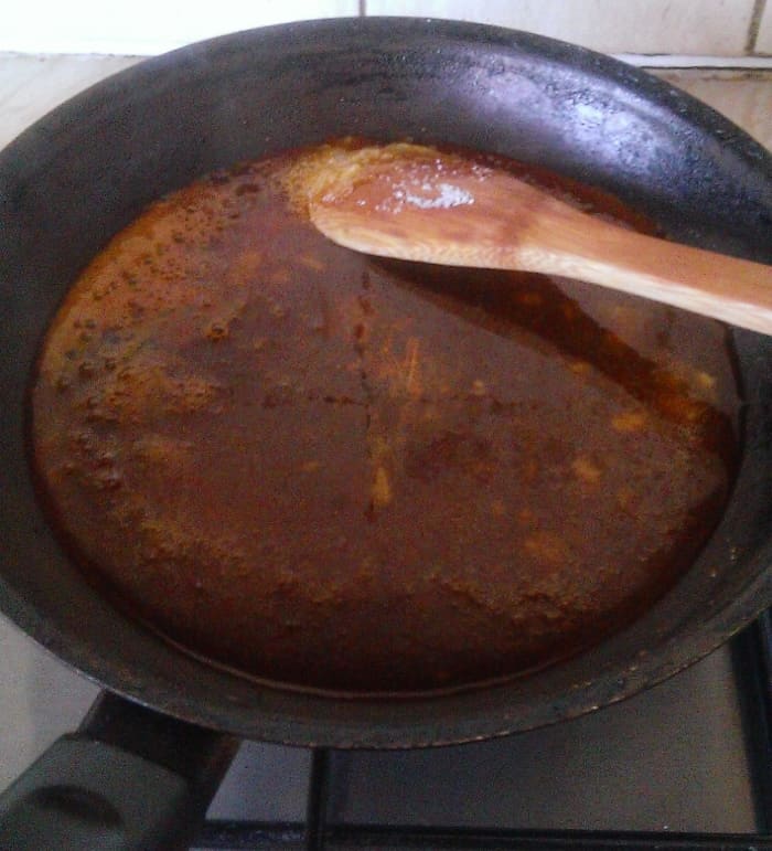 Sugar once it has turned into Caramel. Turn off heat, add in the peanuts and mix it well into the caramel.