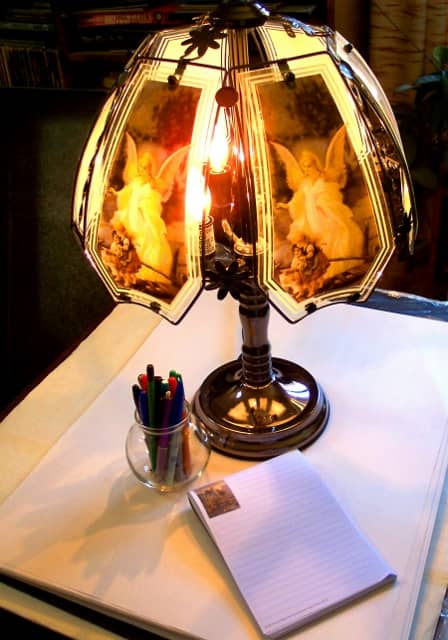Writers are sometimes inspired by a pen, a pad, and a night lamp of floating angels.