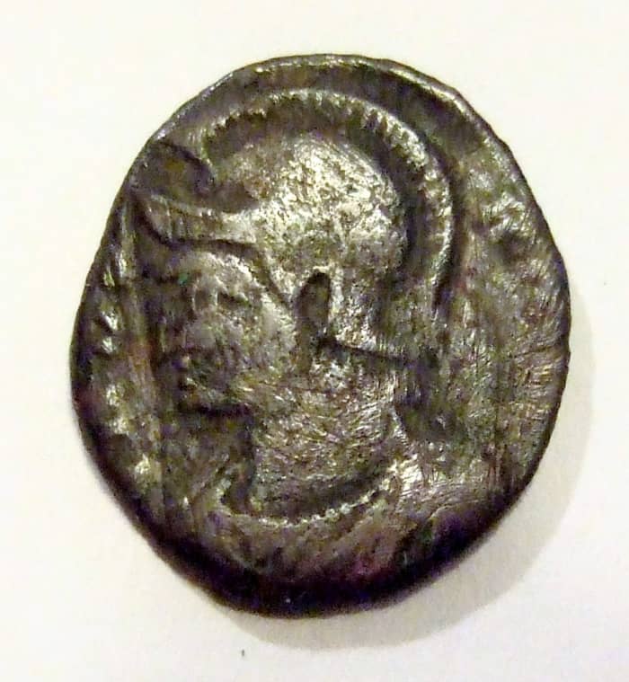 Helmeted portrait of Constantine the Great on this side of the coin, slightly larger but much thicker than a dime.