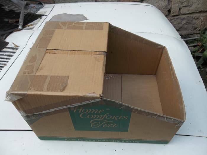 A nesting box made by cutting a carton. In a later successful model, the 'roof' cover was left out without affecting the outcome.