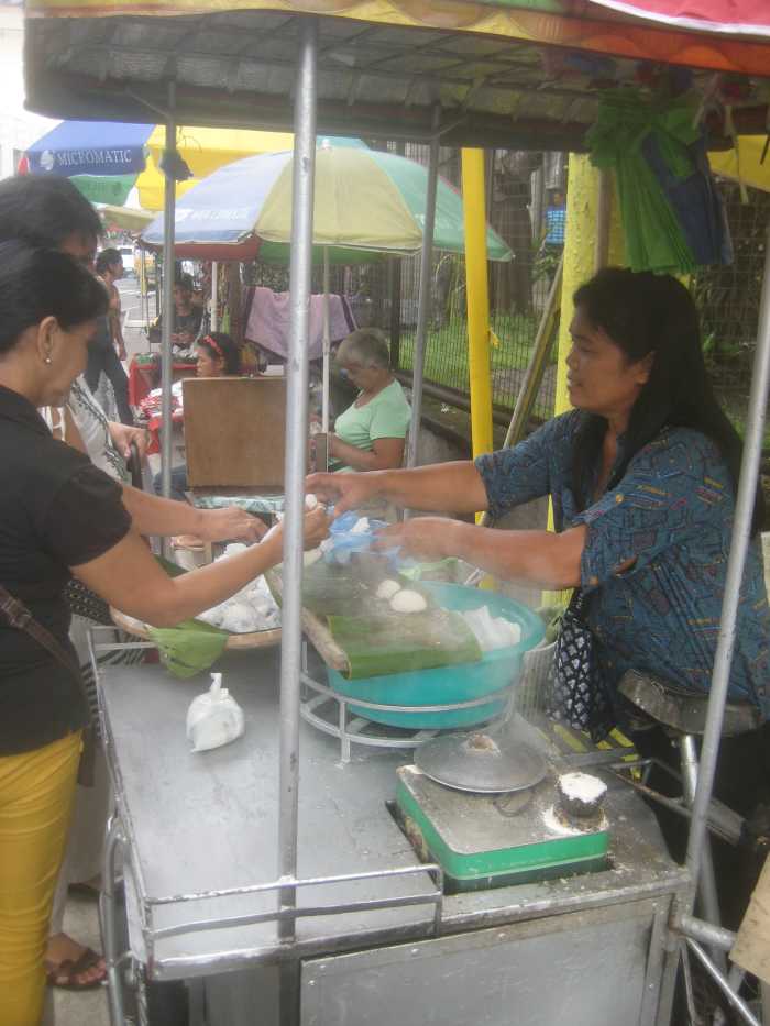 She's the only one selling rice cakes in Naga City, Bicol, Philippines, just outside the premises of San Francisco Church.