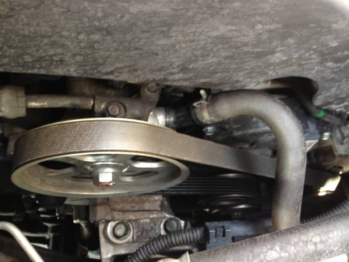 The accessory/"serpentine" belt is crucial to operating parts like the A/C compressor and alternator. Check these for signs of wear (and listen for screeching/whirring pulley-bearings too).