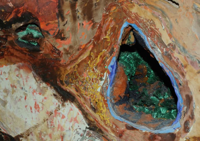 This image shows two parts of a section of a wall of a cave near Brisbee, Arizona. It is on display at the Smithsonian Museum of Natural History.