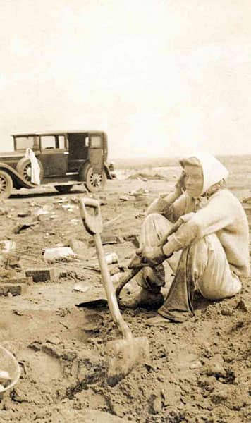 Hollywood actress, Katharine Hepburn, sitting in the muddy debris of her destroyed family beach home after the Great New England Hurricane of 1938
