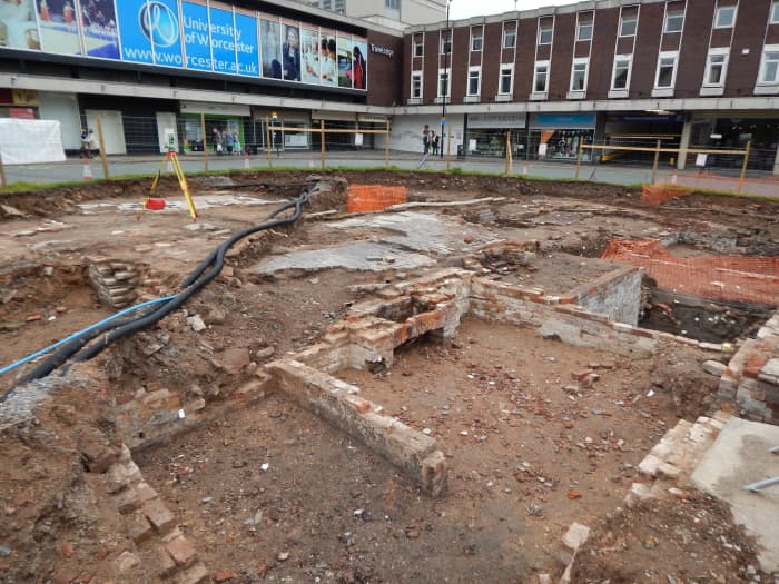 The old well, marked with a bright orange plastic barrier fence, near the centre of this photograph, would have been the main water supply during the 1800s in Lich Street.