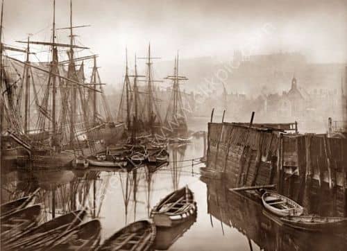 ... Of long summer evenings, cold winter chill on the still harbour waters of Old Whitby. This is along the quayside looking seaward, with St Mary's church just visible near the clifftop (right) next to the ruined abbey