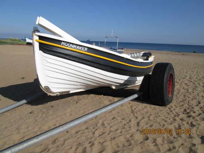 Not far south, a coble has been drawn up on its trailer onto the sands below Marske village